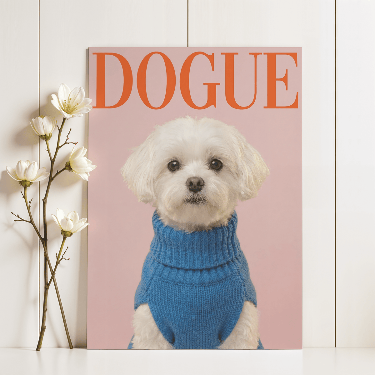Maltese Dog wall art of a white dog in a blue jumper with large orange text and flowers on a white wall