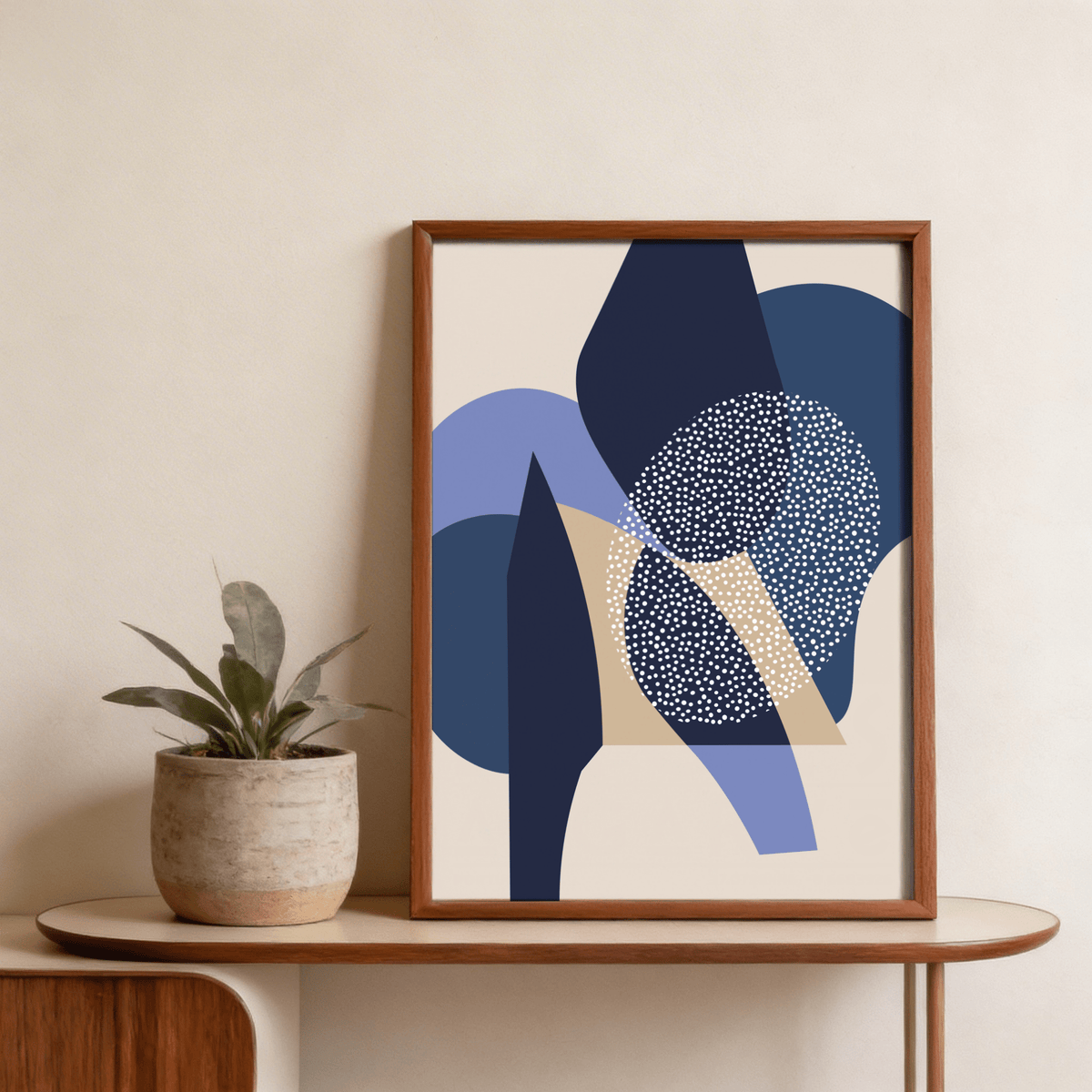 Blue Abstract Print leaning on a wooden shelf with a plant pot nearby