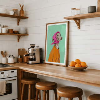 Greyhound poster leaning on a kitchen counter with wooden stools and a bowl of oranges nearby