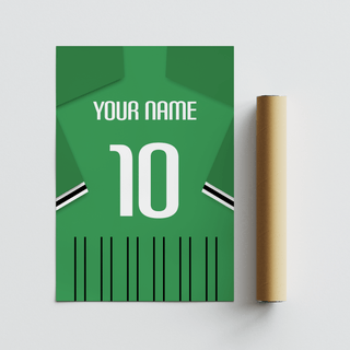 Rolled print next to a green football shirt poster with black and white sleeve stripes on a white surface