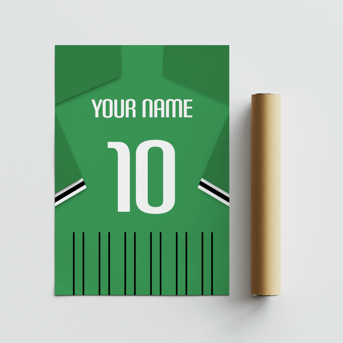 Rolled print next to a green football shirt poster with black and white sleeve stripes on a white surface