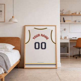 Print leaning on floor of basketball jersey poster in white with yellow and navy trim beside a wooden bed