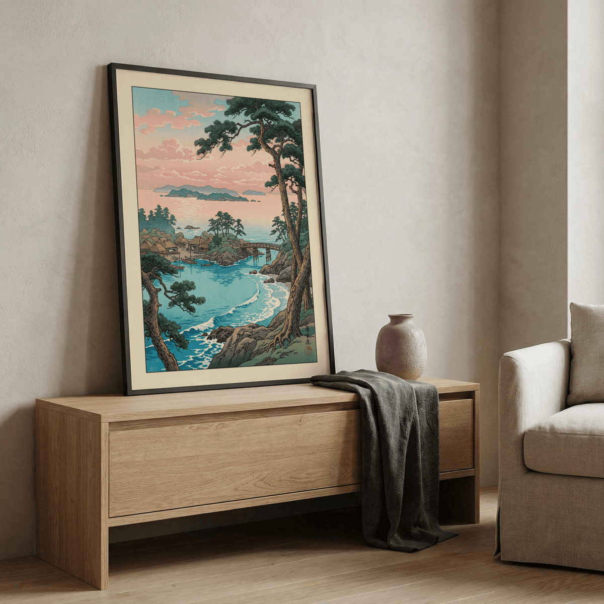 Hasui Kawase Sea Landscape Print leaning on a wooden sideboard with a grey cloth and pottery vase