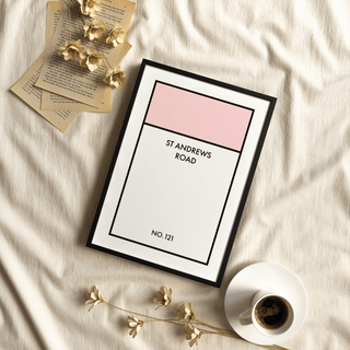 Framed Street Name Family Personal print with pink and white blocks beside a coffee cup and dried flowers