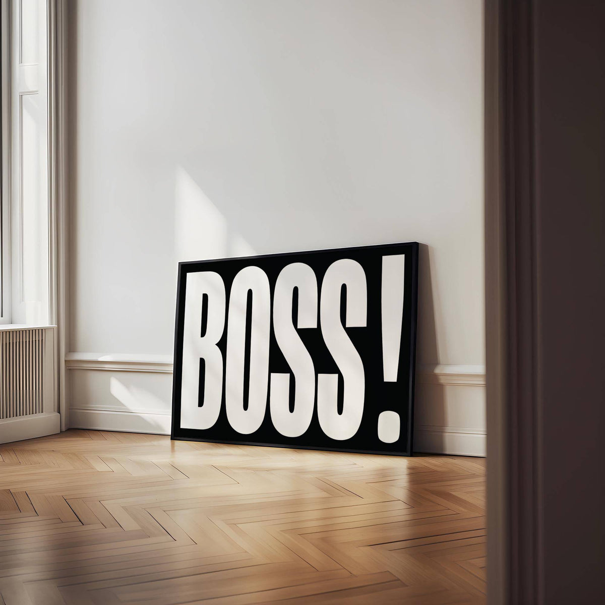 Print leaning on a parquet floor wall with large BOSS typography in white on black background