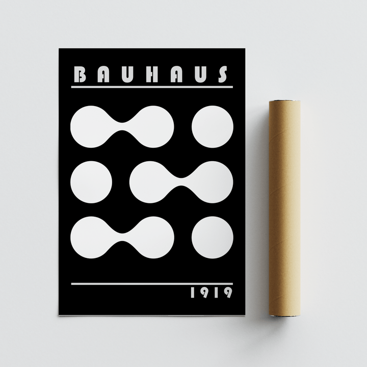 Abstract geometric print with white Bauhaus shapes on black next to a packaging tube