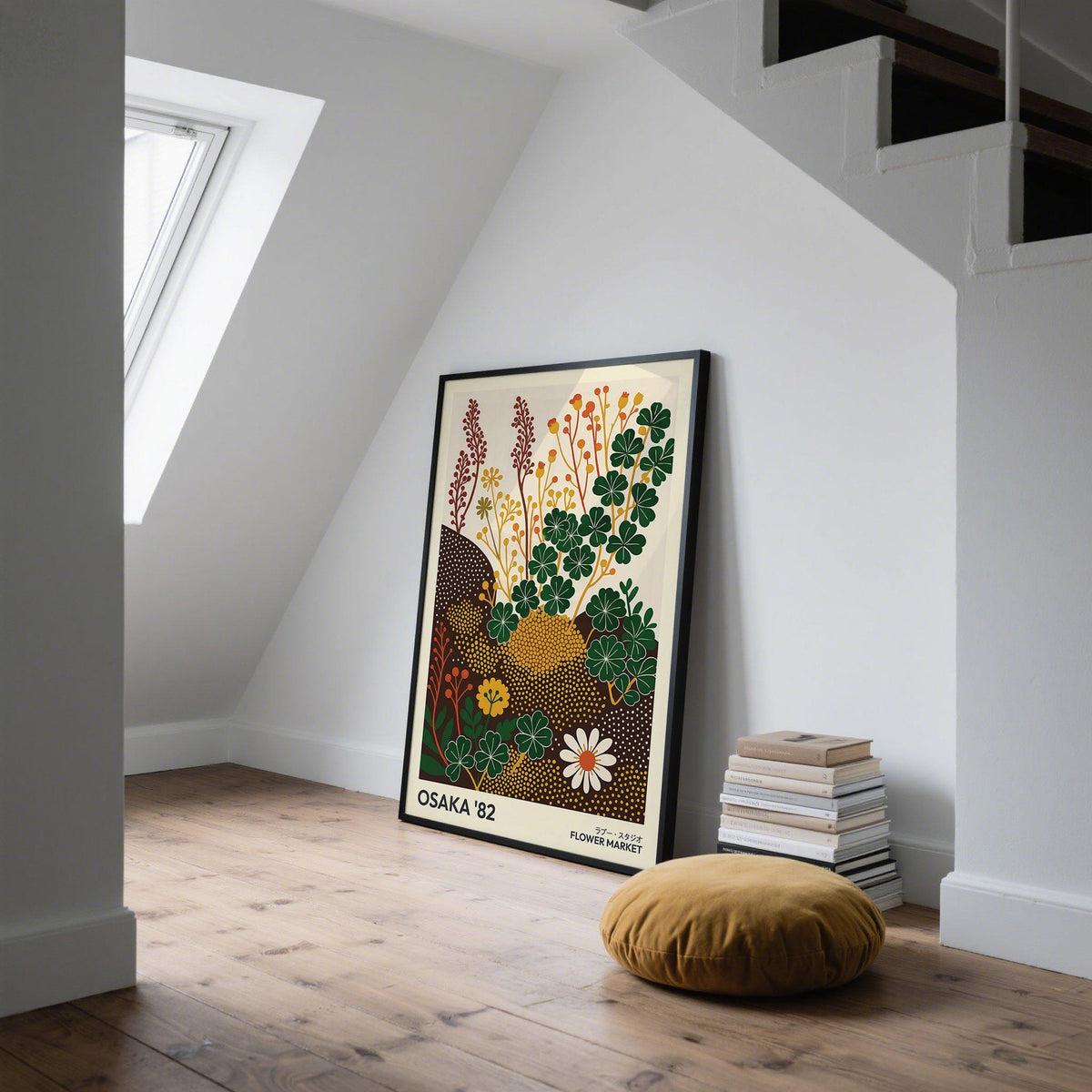 Wildflower art prints leaning on the floor showing clover and wildflowers in green yellow and brown next to a cushion