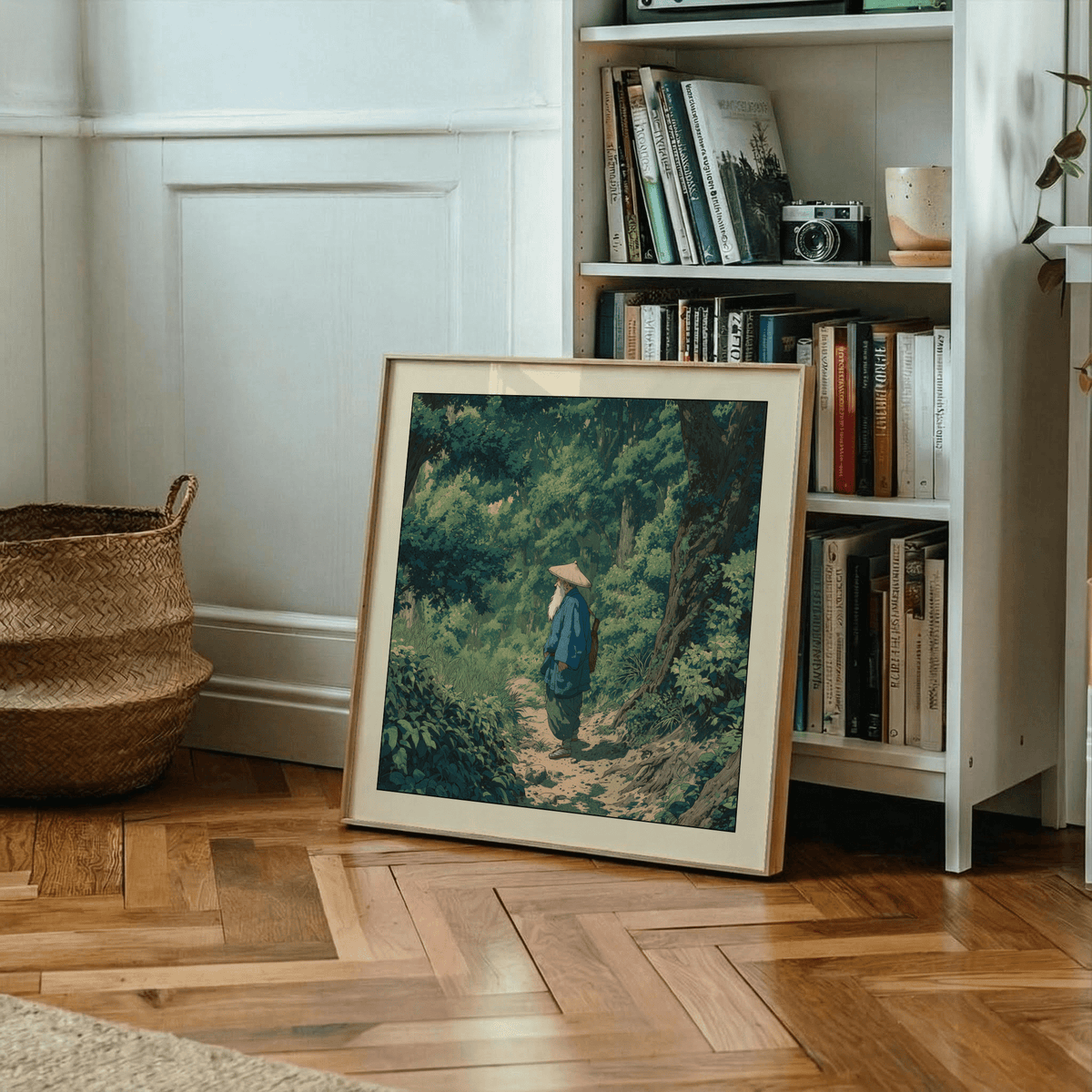 Print leaning on a wooden floor showing an old man in a green forest with a large basket next to it