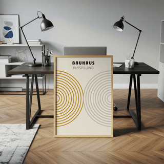 Minimalist wall decor leaning on a desk with black lamps and office supplies in a workspace