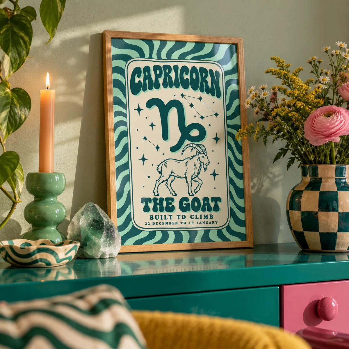 Capricorn Print, a small A4 framed print leaning on a colourful lacquered shelf in a living room