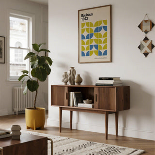 Bauhaus Geometric Art framed print with lime green and blue blocks above a wooden sideboard in a living room