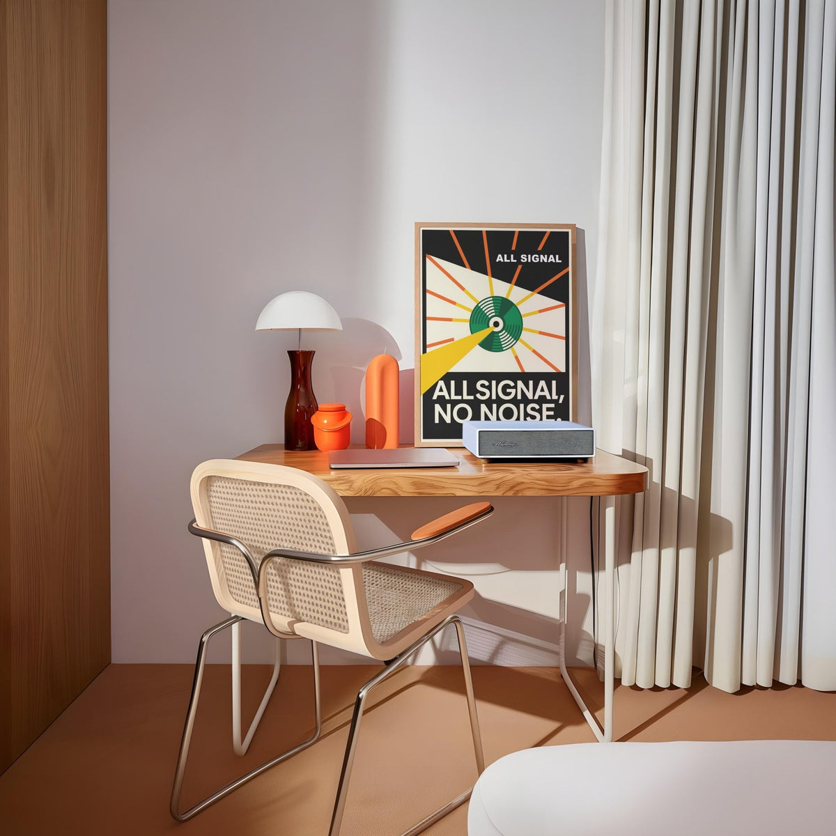 Vinyl Record Poster leaning on a wooden desk with a white lamp and orange vase in a softly lit room