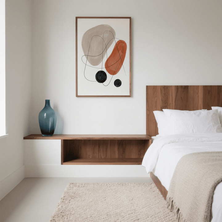 Abstract Shapes Art Print on a bedroom wall with red brown, beige and black shapes above a floating wood shelf with blue vase
