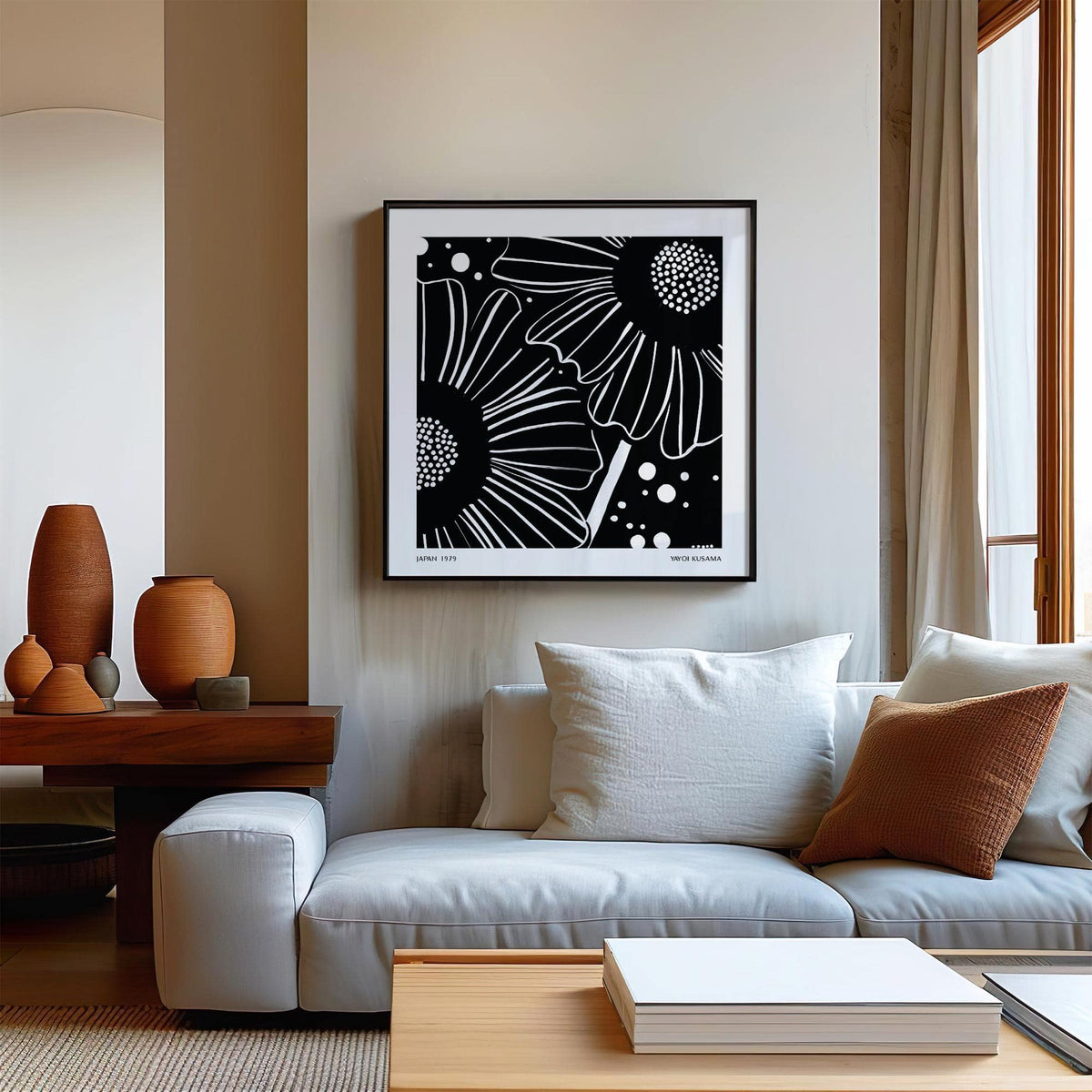 Black White Floral Art framed print with minimalist daisy flowers hanging above sofa in living room