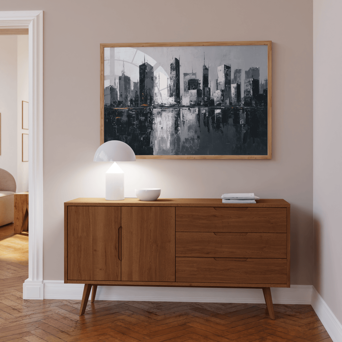 City skylines wall art of a monochrome abstract city reflected in water above a wooden sideboard with a lamp