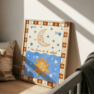 Print leaning on a floor with crescent moon and sun illustration in blue and brown near cushions