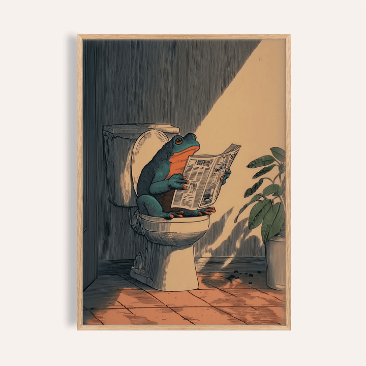 Frog Bathroom Art framed print close-up of a frog on a toilet reading a newspaper with a plant beside it