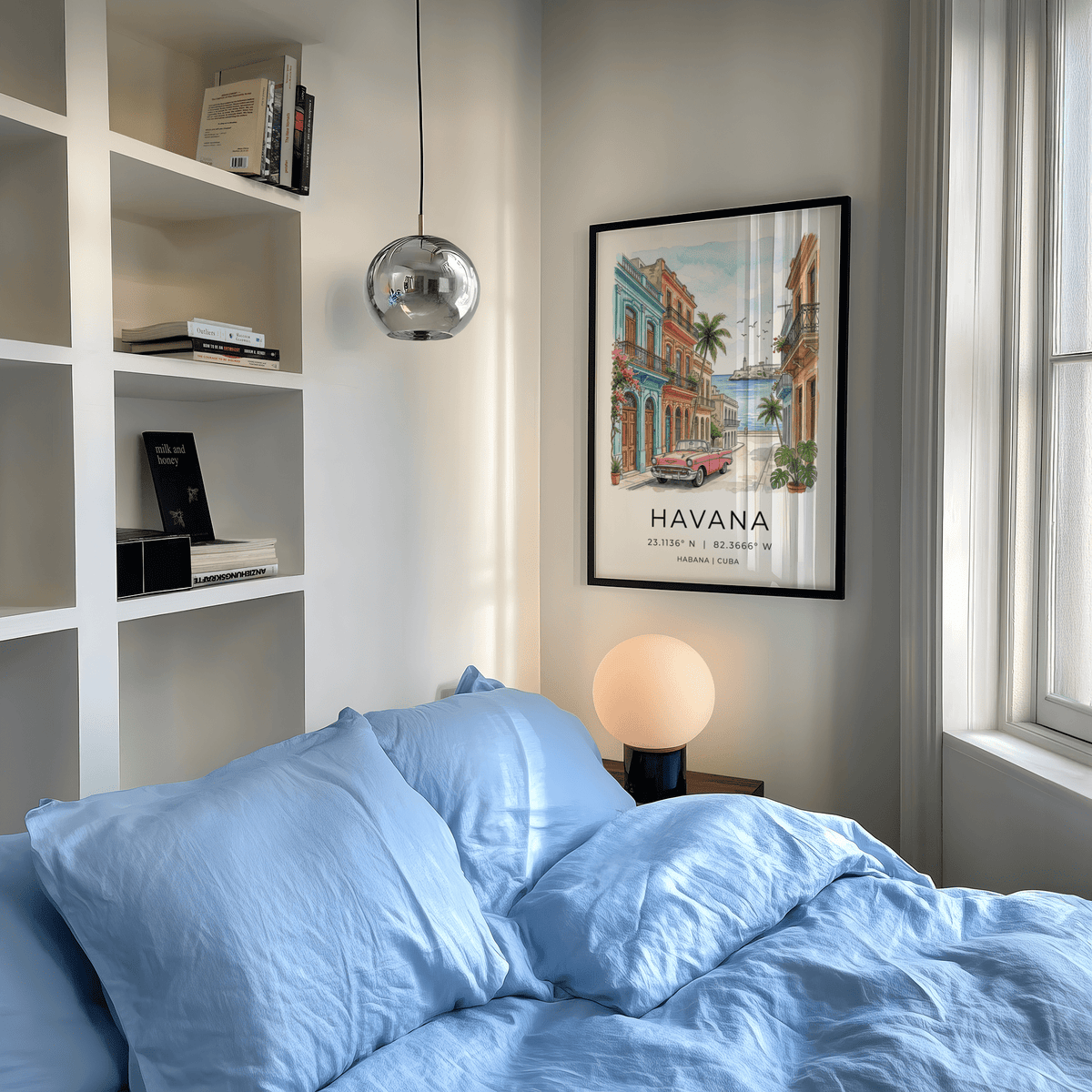 Framed Havana wall art of a pink vintage car and colourful buildings above a side table with a spherical lamp