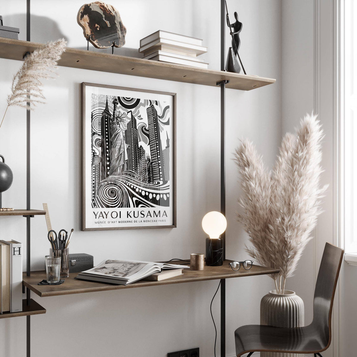 New York Cityscape wall art in black white and grey above a desk with books and a lamp