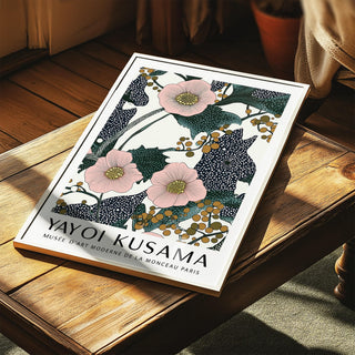 Pink wall art for bedroom with pink flowers and berries print leaning on a wooden table