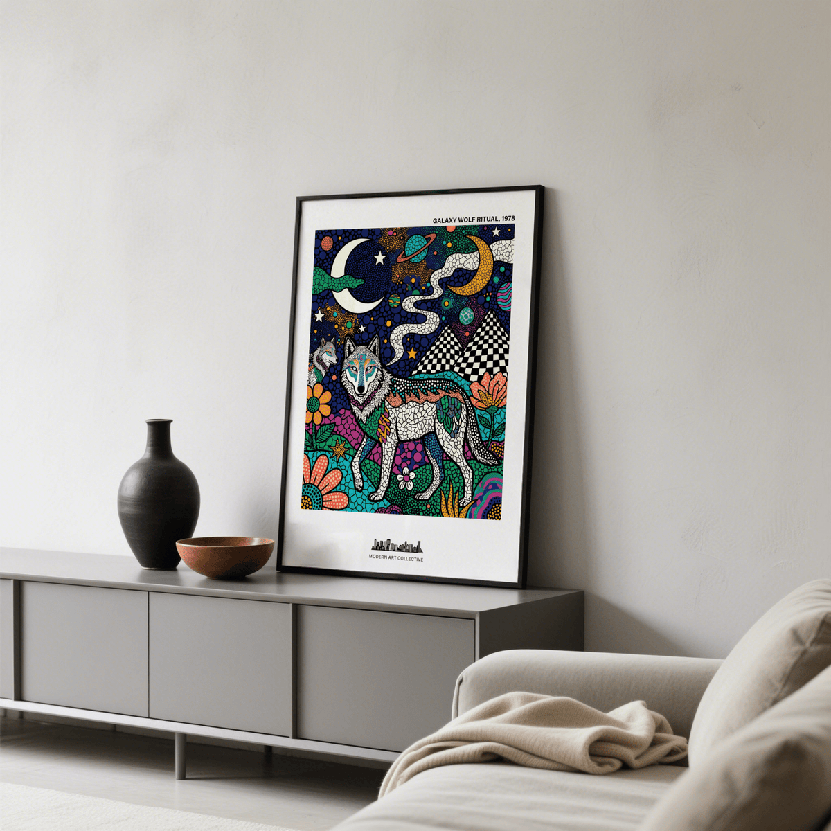 Wolf Galaxy wall art leaning on a cabinet with a black vase and bowl in a living room
