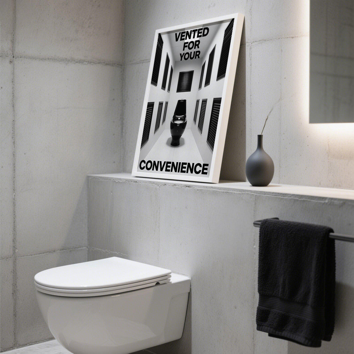 Print on a ledge showing a black toilet and text with a dark vase nearby