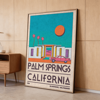 Palm Springs Art Print leaning on a wooden floor with retro desert house illustration in teal and orange beside a mid-century cabinet