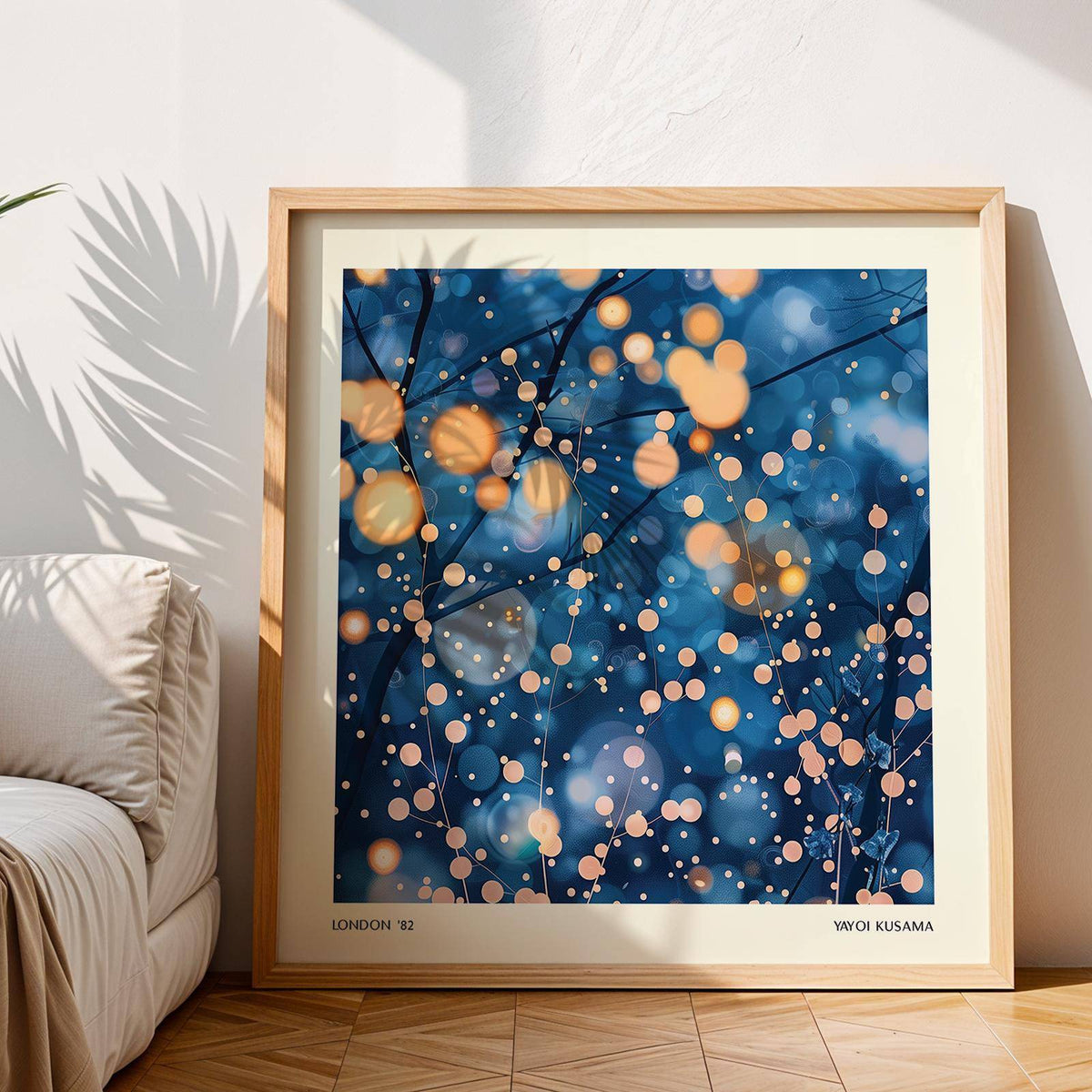 Framed Modern Painting Prints featuring branches with yellow and blue lights leaning against a wall beside a sofa