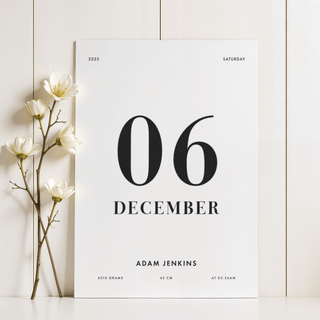 Born This Day Custom print leaning on a white surface with white flowers to the left