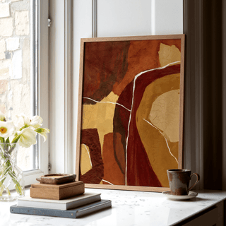 Abstract Earth Tones Print leaning on a windowsill with earth tone shapes and a brown mug nearby
