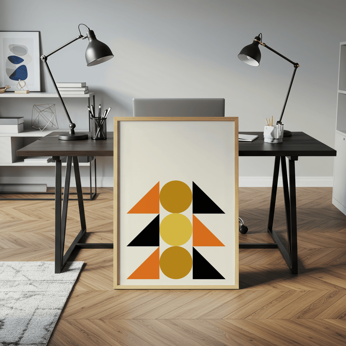 Geometric Block Art print leaning on a desk with black and orange shapes in a modern office