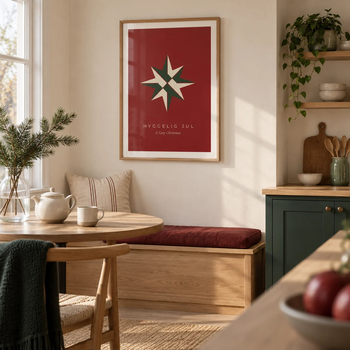 Christmas Star Print, framed on the wall of a modern Scandinavian kitchen breakfast nook in a UK home with plain cream walls and forest green lower cabinets