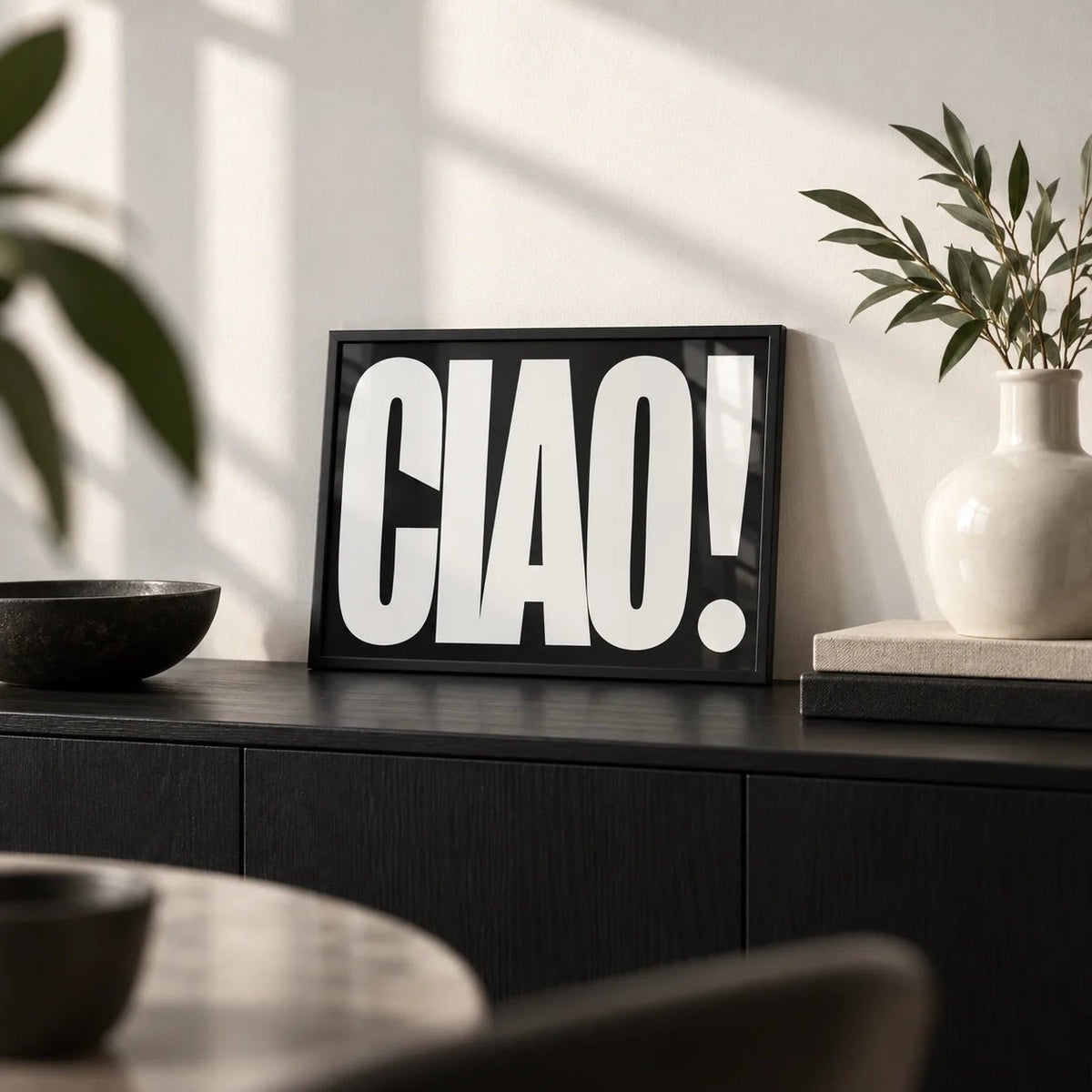 Ciao Poster, a small A4 framed print leaning on a black sideboard in a living room