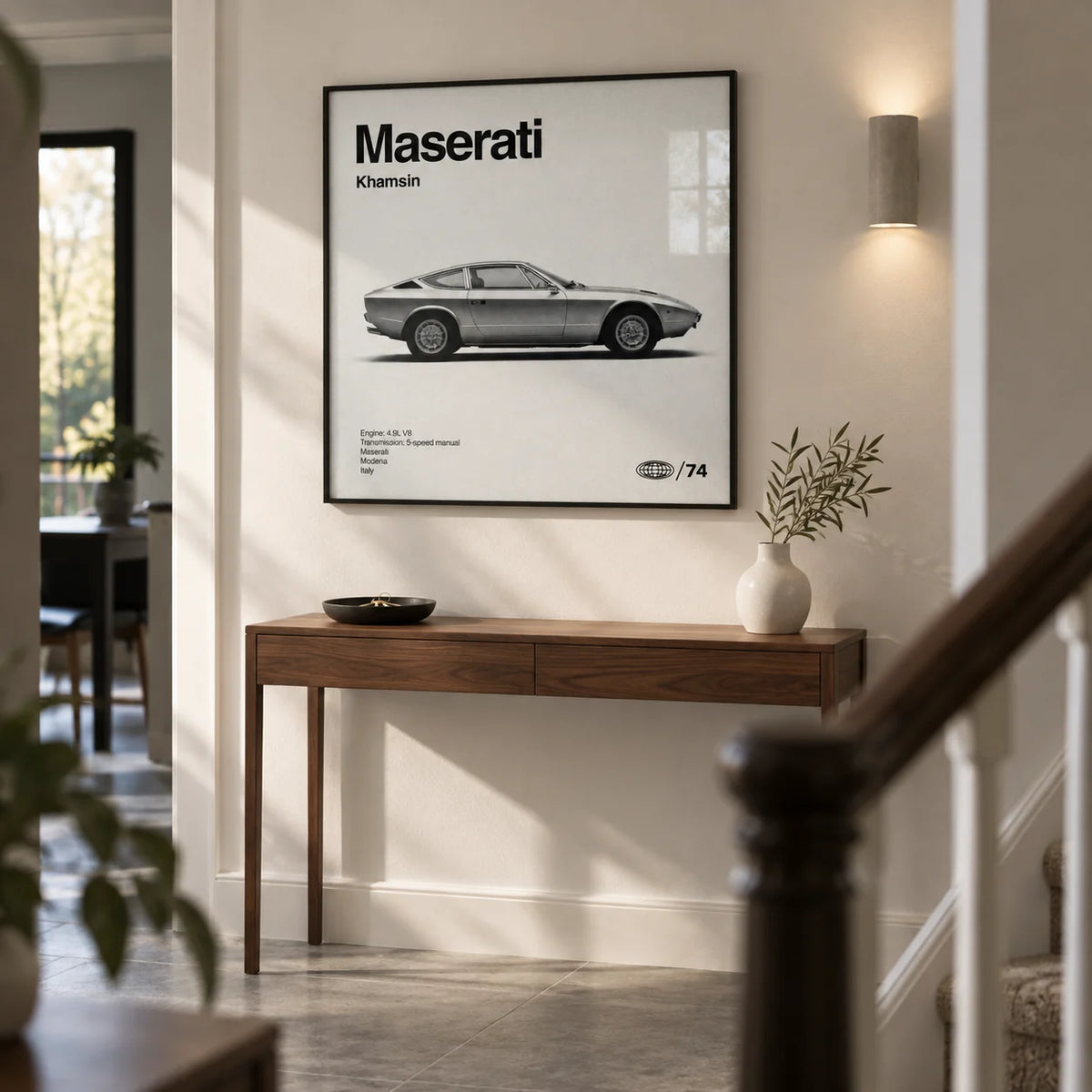 Classic 1970s Grand Tourer Poster, framed on the wall of a modern hallway in a UK townhouse with warm white walls and a plain grey stone floor