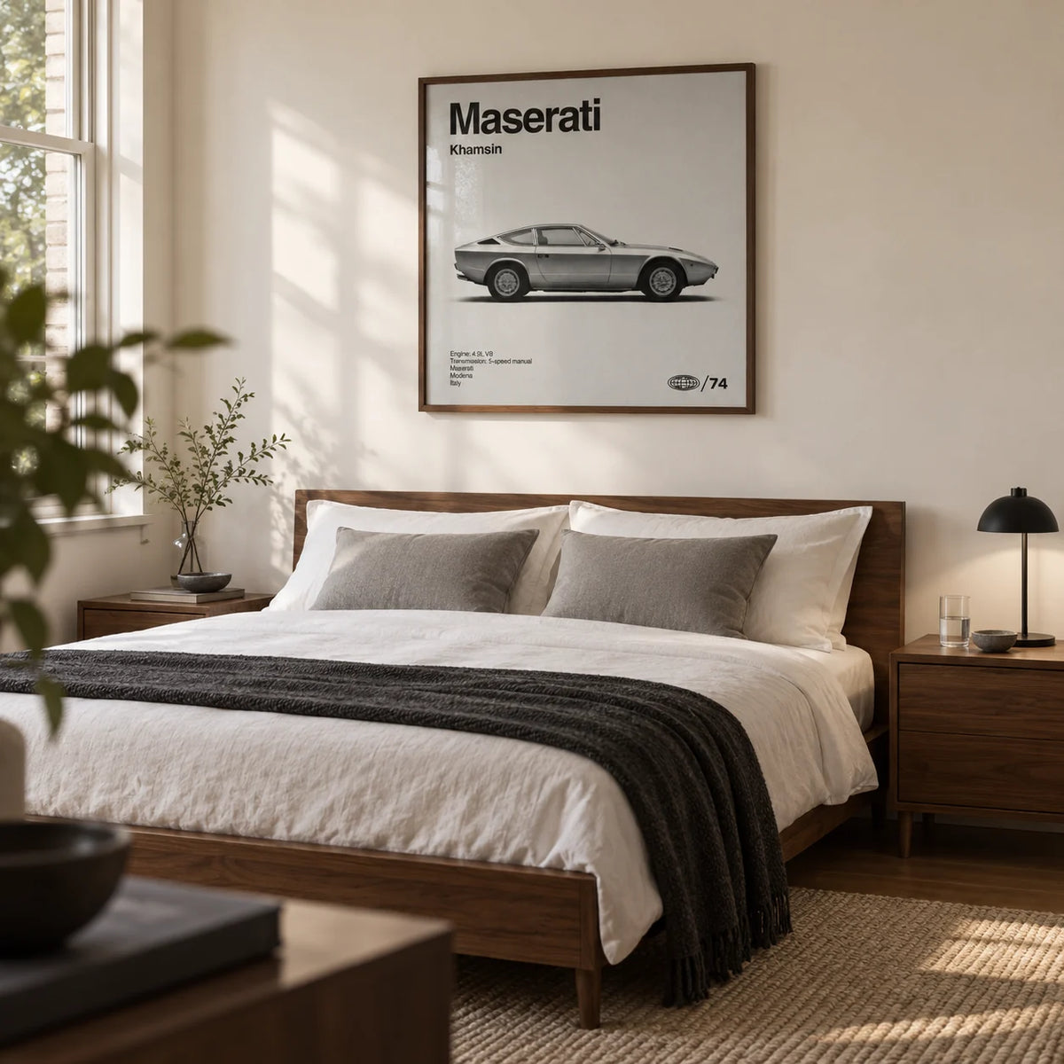 Classic 1970s Grand Tourer Poster, framed on the wall of a restrained bedroom for a classic-car enthusiast in a UK home with a warm white wall and walnut bedside furniture