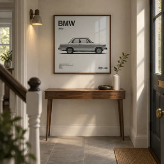 Classic 1970s Sports Saloon Poster, framed on the wall of a narrow entrance hallway in a renovated UK terrace with a warm white wall and plain grey floor tiles