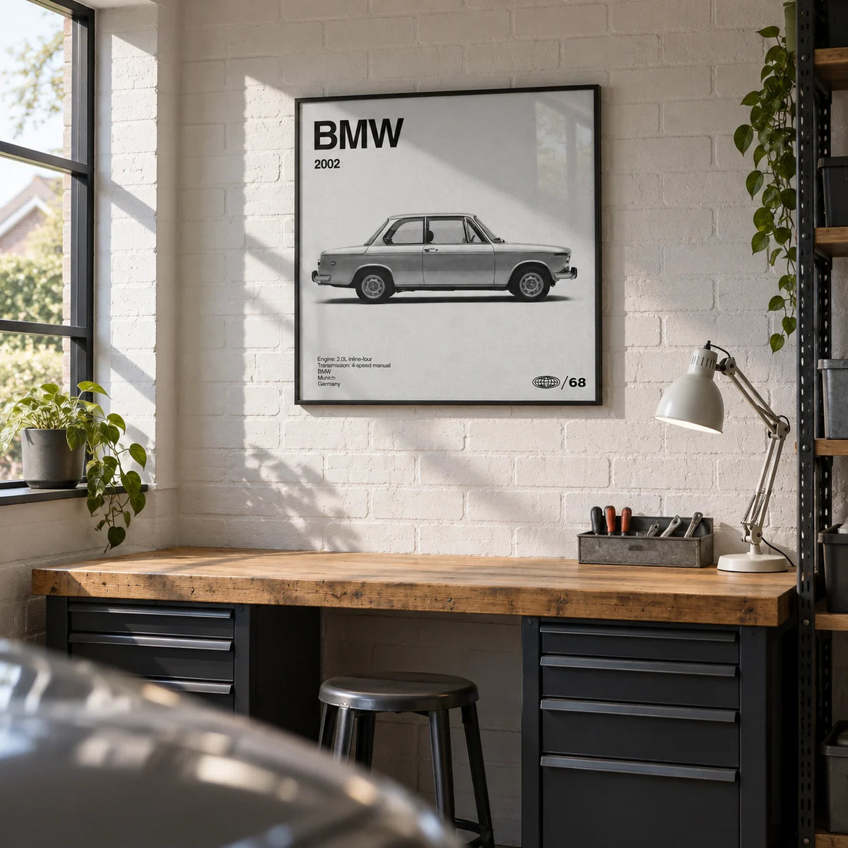Classic 1970s Sports Saloon Poster, framed on the wall of a tidy converted garage hobby room in a UK suburban home with a white painted brick wall and a clean grey concrete floor