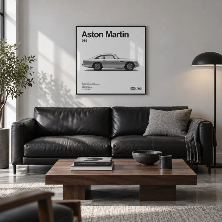 Classic British Grand Tourer Poster, framed on the wall of a design-led city flat living room with a pale grey wall and a polished concrete floor