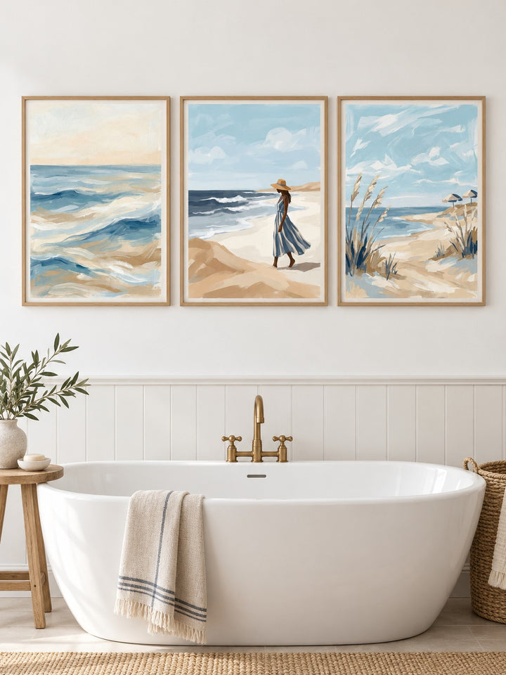 Coastal Wall Art Set hung at eye level above a freestanding bath: Ocean Wave, Coastal Woman Print and Coastal Breeze shown framed side by side (frames not included)