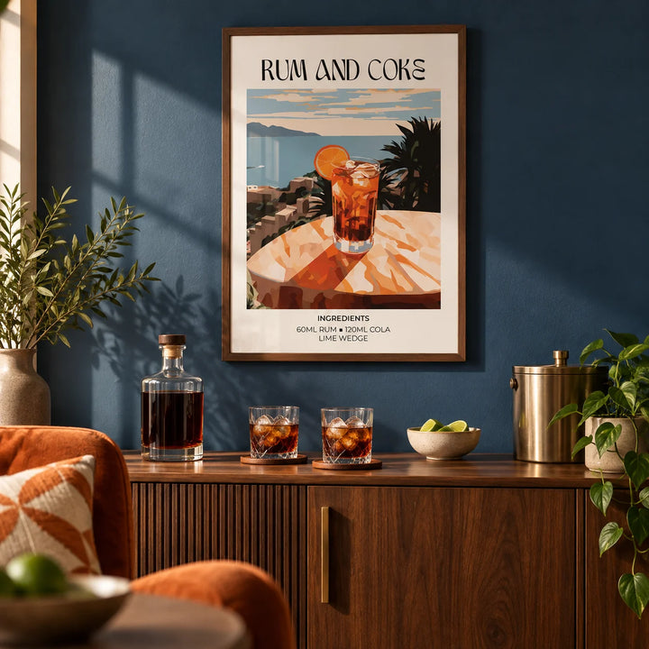 Cocktail recipe poster, framed on the wall of a warm home bar corner in a living room with a deep blue painted wall