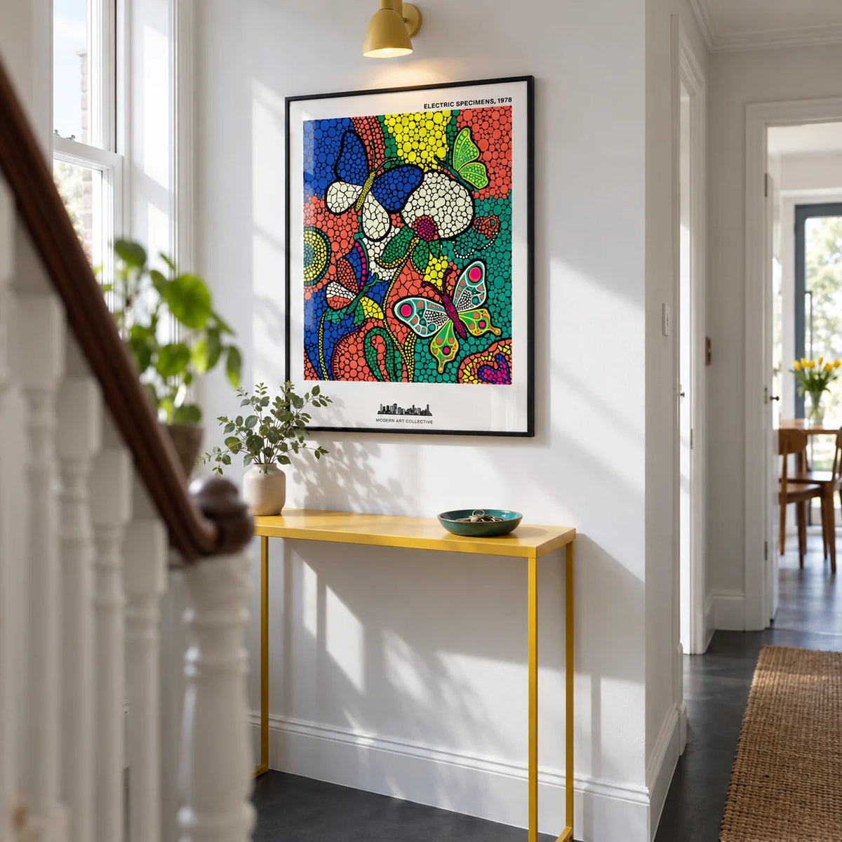 Colorful Butterfly Art Print, framed on the wall of a bright narrow hallway in a renovated UK terrace with white walls and a plain charcoal floor
