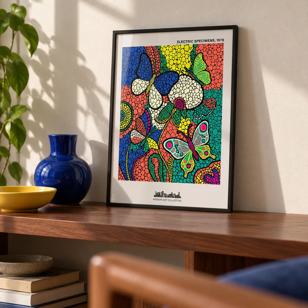 Colorful Butterfly Art Print, a small A4 framed print leaning on a walnut shelf in a living room
