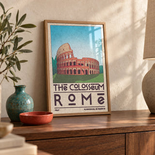 Colosseum Art Print, a small A4 framed print leaning on a walnut sideboard in a living room