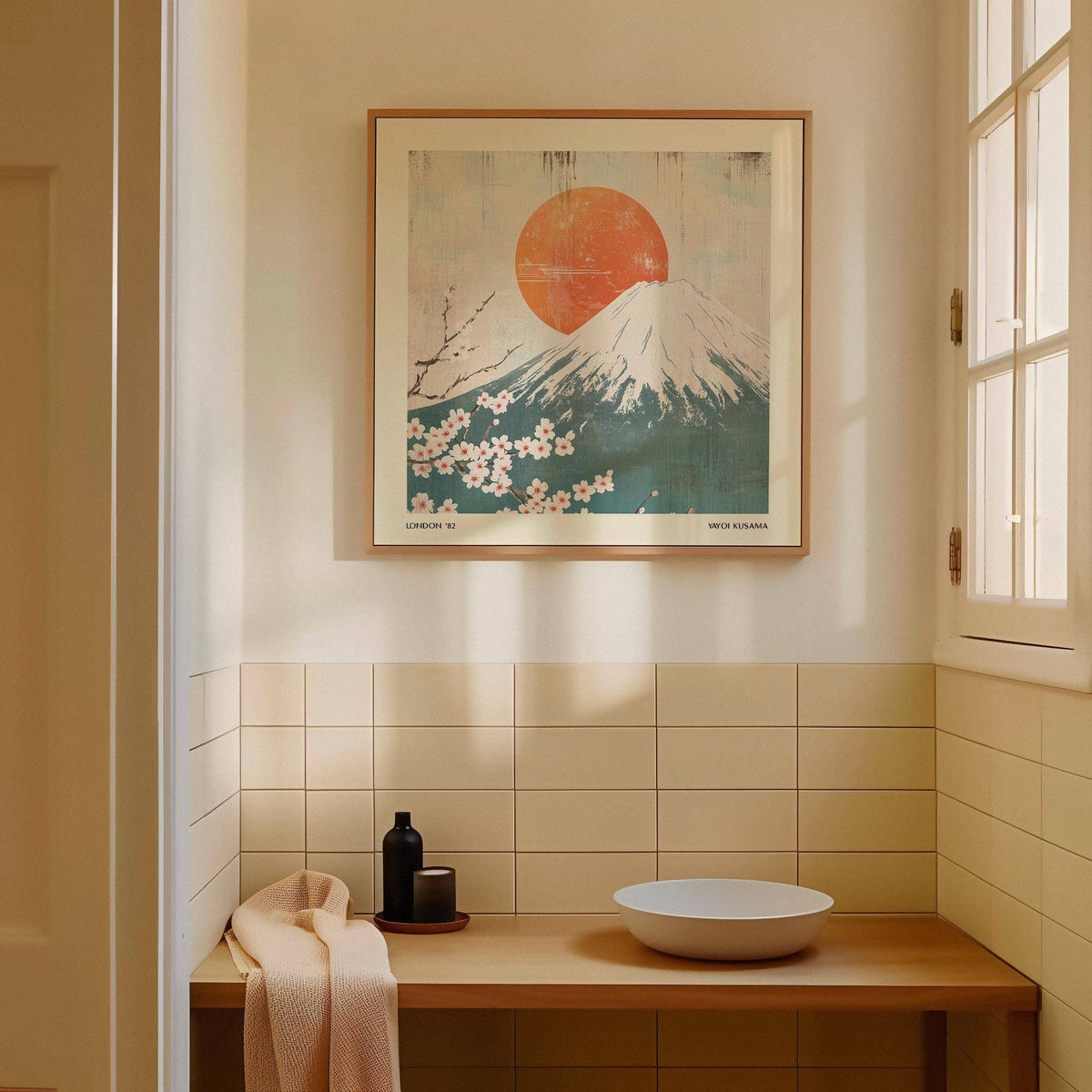 Square print of Mount Fuji with cherry blossoms in Japanese woodblock style above a wooden sink in a softly lit room