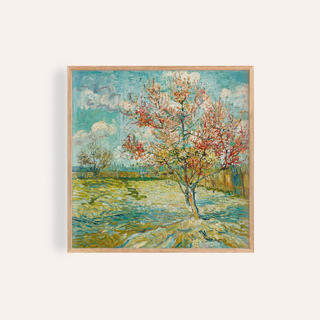 Framed Impressionist wall art of a flowering tree with blue sky and green grass