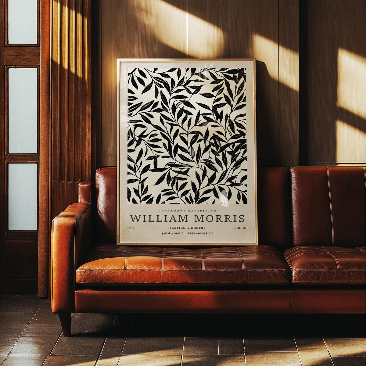 Black and White Vintage Wall Art of black leaf branches pattern leaning on a brown leather sofa