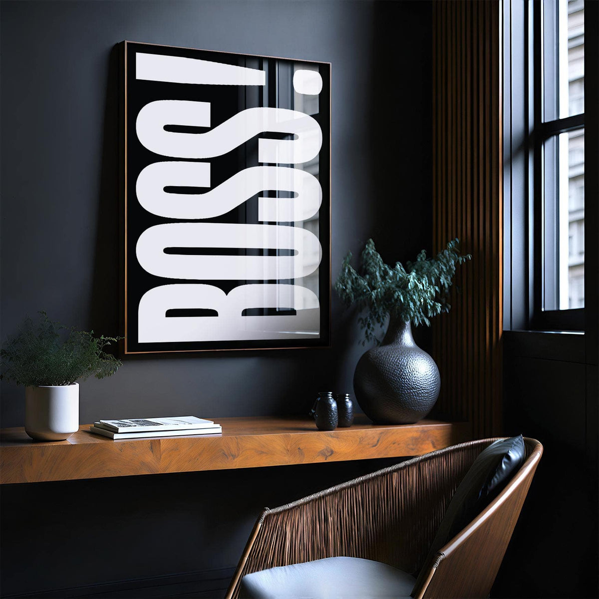 Print on a wall with bold white BOSS typography on black above a wooden shelf with plants and books
