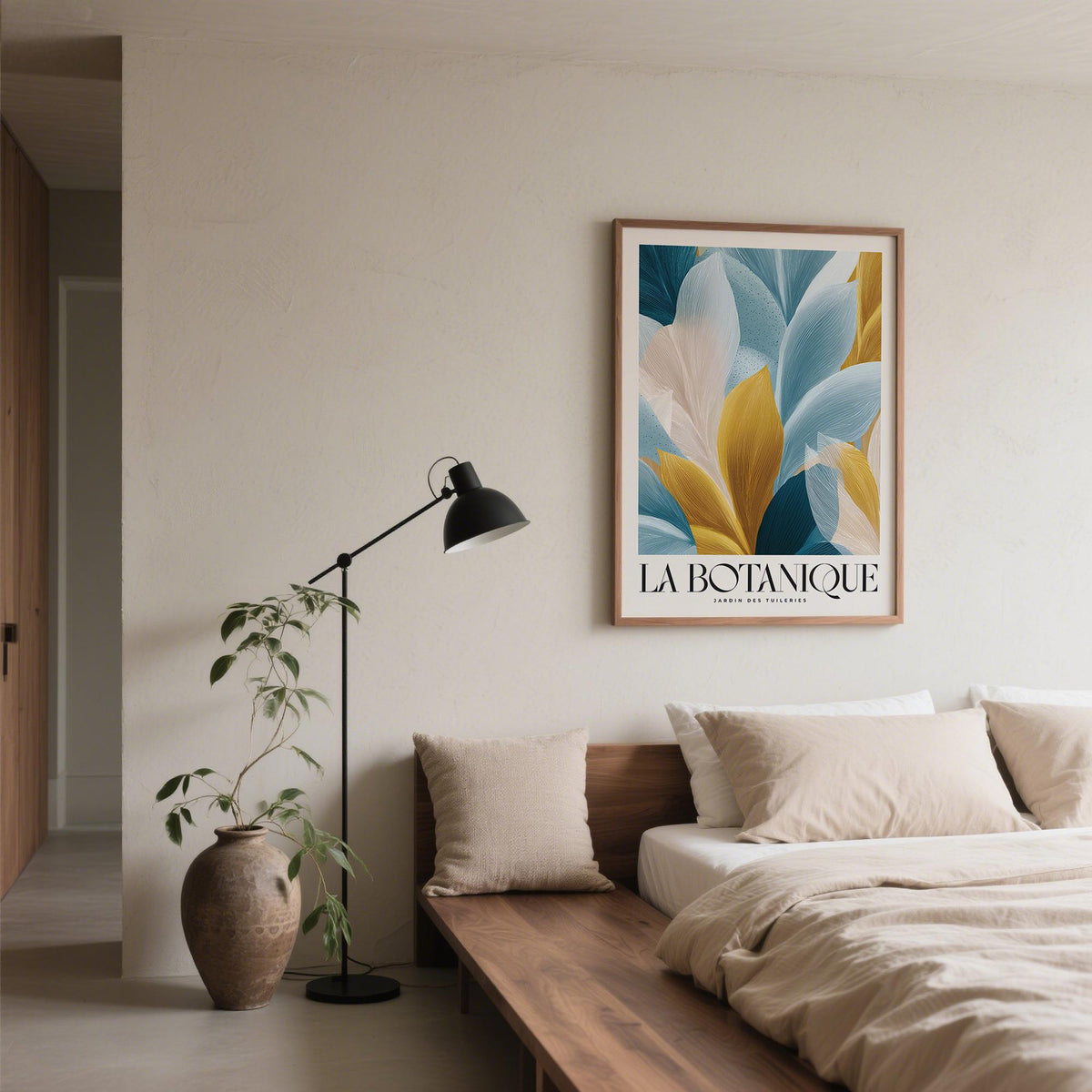 Wall Art Blue and Gold framed print of abstract botanical leaves in blue and gold tones above a bed in a bedroom