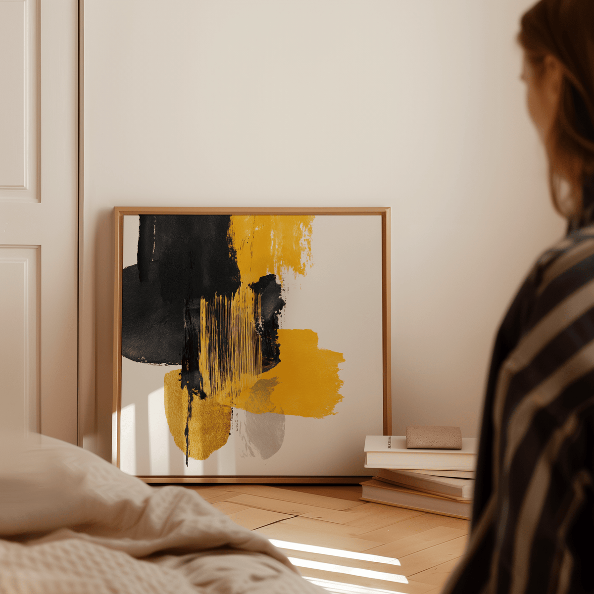 Abstract Poster Art print with black and yellow brushstrokes leaning on the floor near books