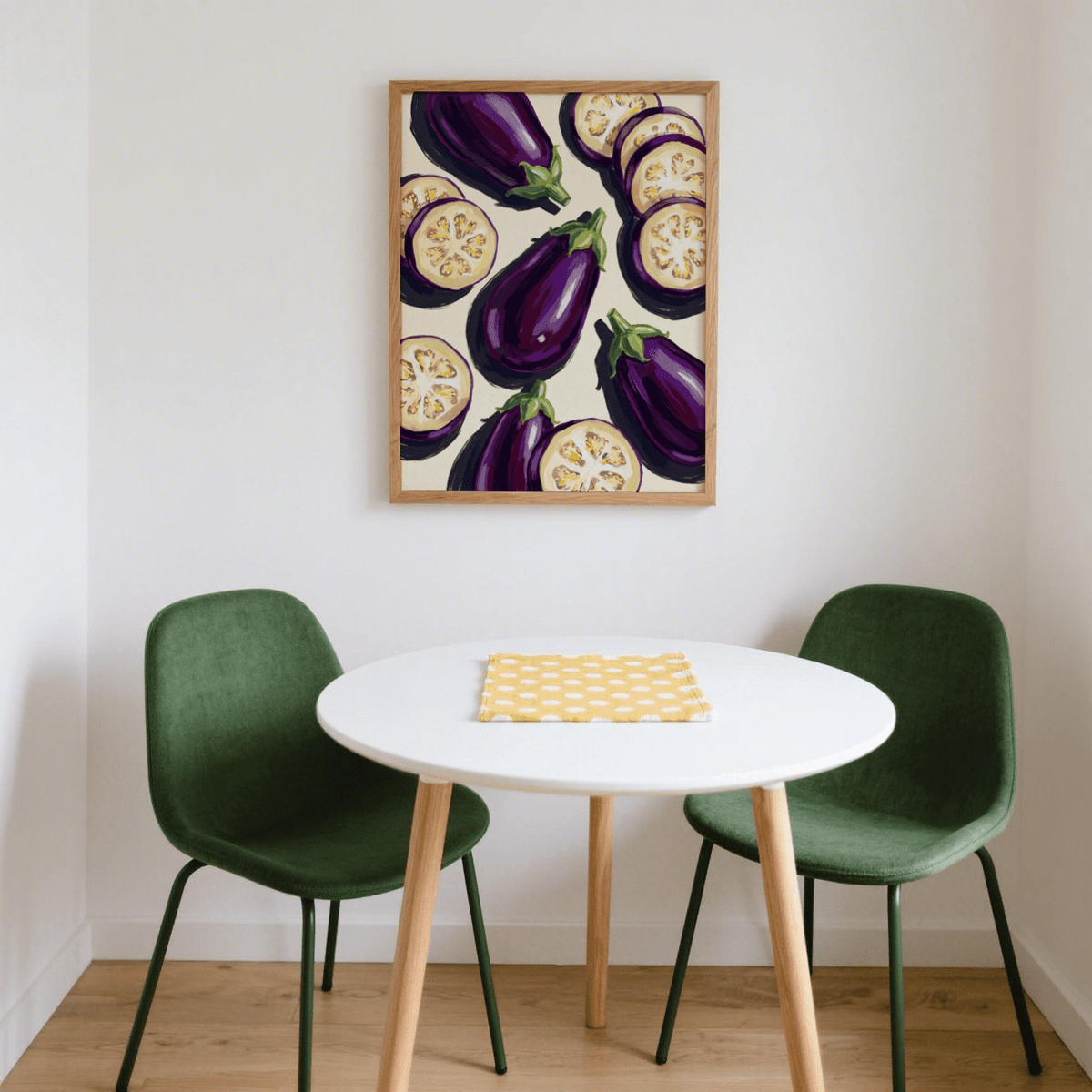 Aubergines Art Print hanging above a white round table with green chairs in a dining area